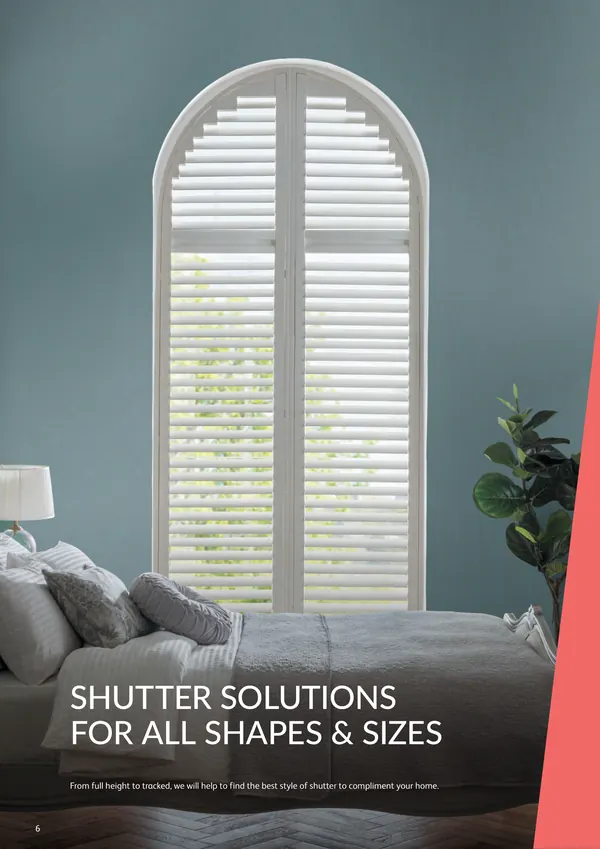 Teal bedroom with arched shutters on a tall window