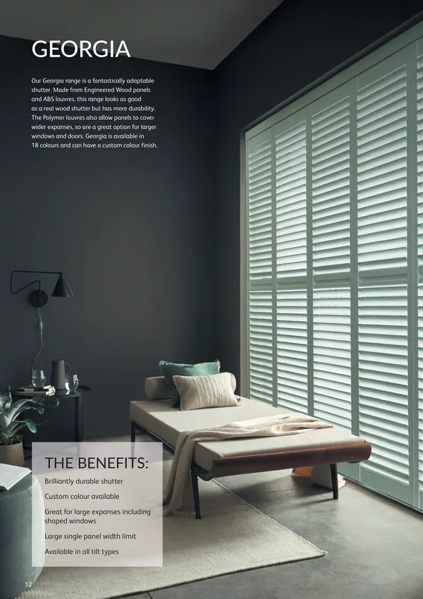 Dark bedroom fitted with black Georgia shutters