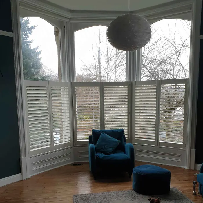 Sitting room bay with café-style shutters on its lower half