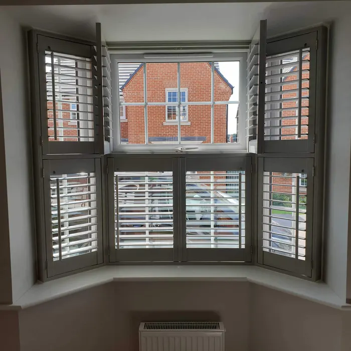 Bay window with tier-on-tier shutters, the upper panels folded back and the lower ones shut