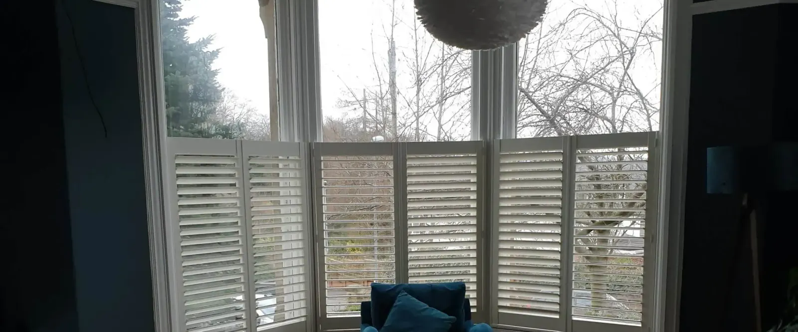 Bay window with shutters covering only the lower half of the glass