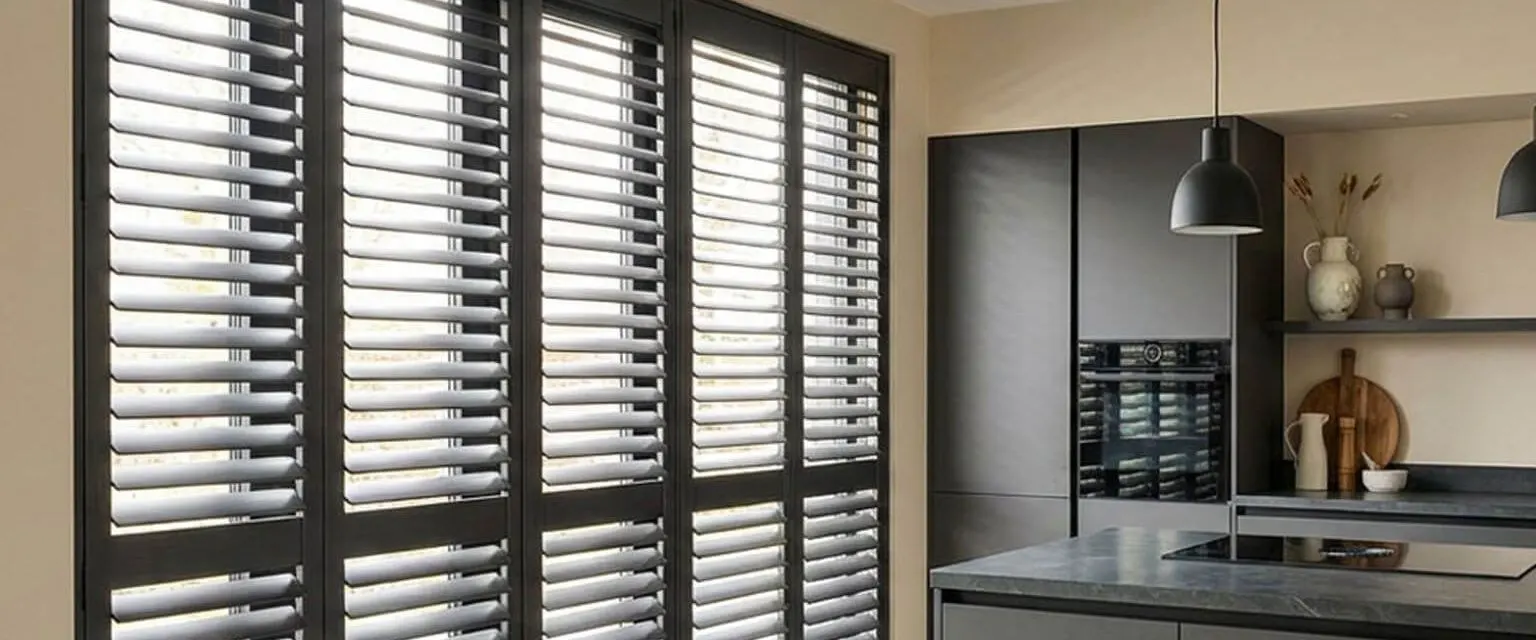 Modern kitchen with grey shutters over the patio doors