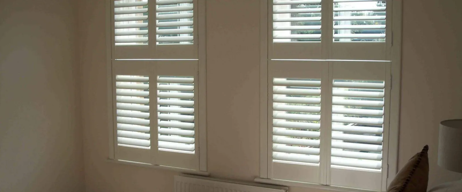 Bedroom window with separate top and bottom shutter panels