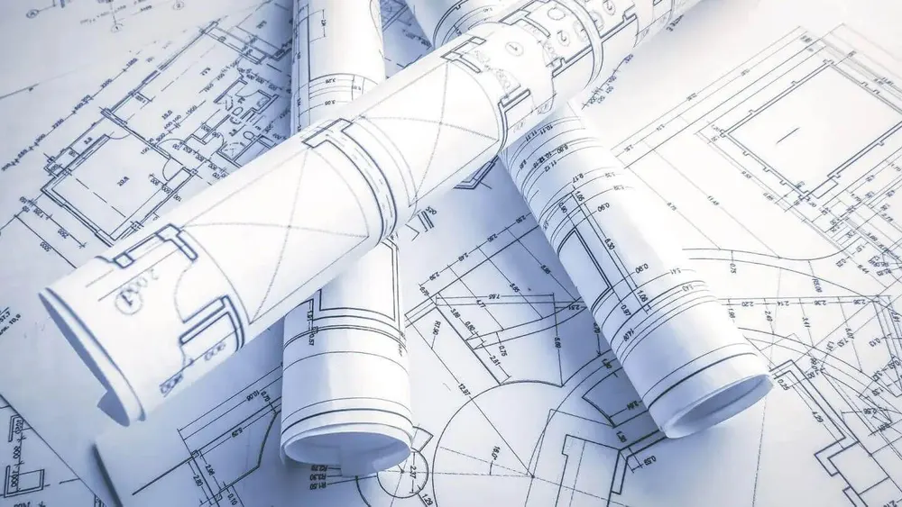 Technical drawings and rolled plans laid out for a shutter order