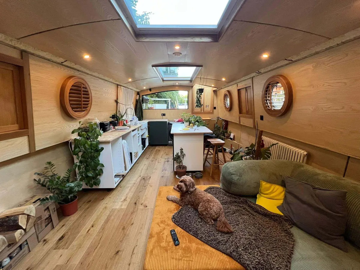 Round wooden shutter fitted over a porthole window inside a narrowboat