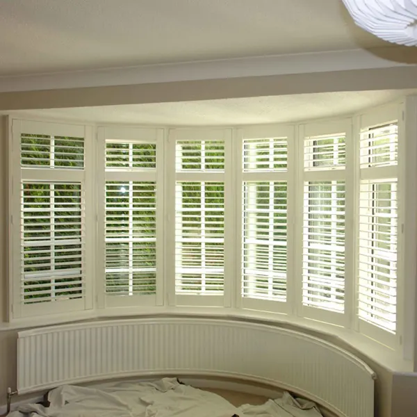 Curved window seat in a deep bay with shutters all the way round