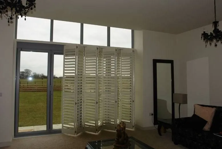 Lounge garden doors covered by bi-fold shutters