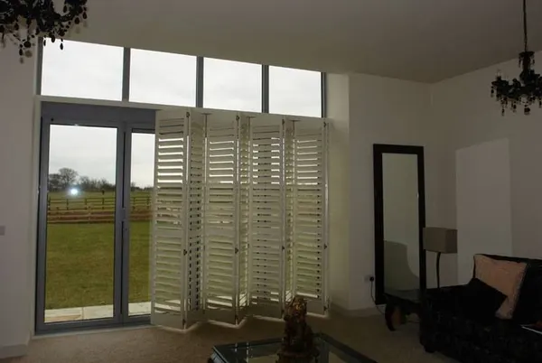 Lounge garden doors covered by bi-fold shutters