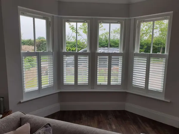 Sitting room bay with café style shutters over the lower sashes
