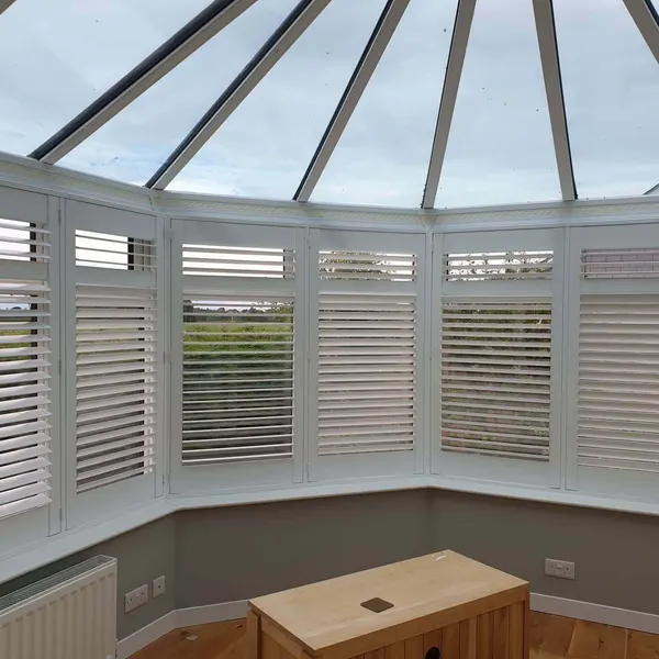 Conservatory roof above shutters on each side pane