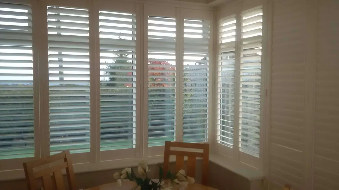 Open louvres along a long run of conservatory shutters