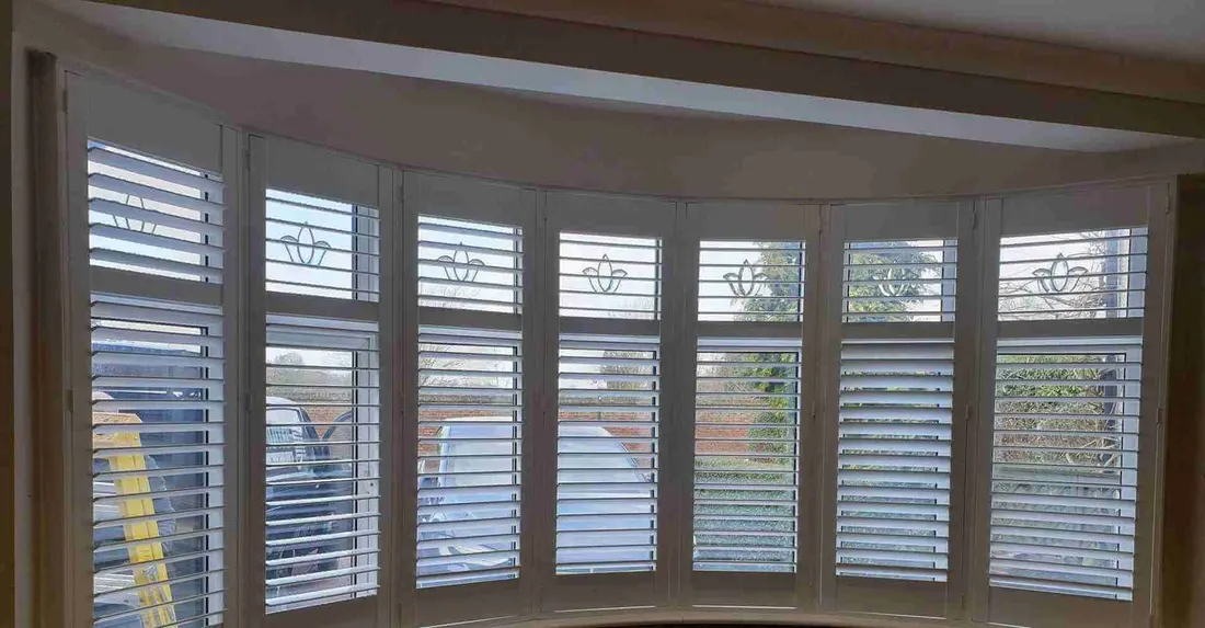 Wide curved bay with a white shutter on each window