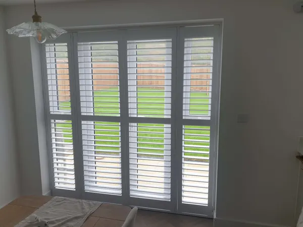 Garden doors with white shutters and a mid rail