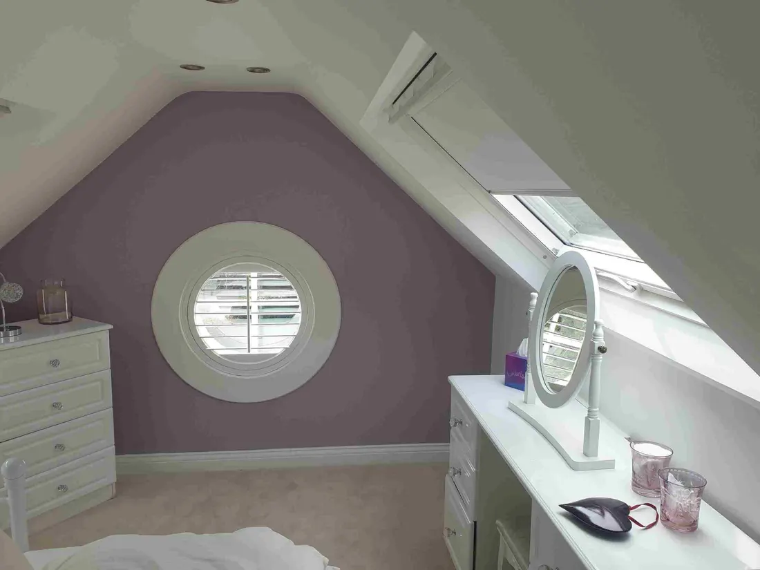 Attic bedroom porthole window with a round shutter