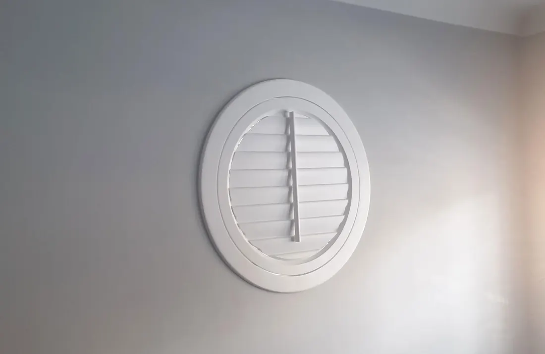 Circular window with its round white shutter closed