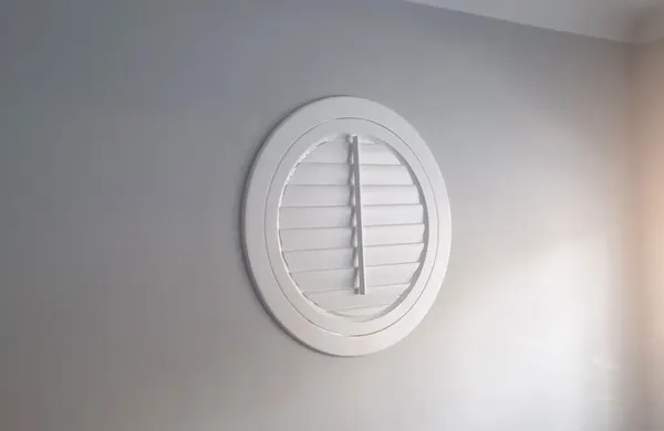 Circular window with its round white shutter closed