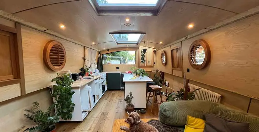 Row of timber porthole shutters along a narrowboat cabin