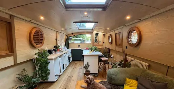Round timber shutters fitted to the portholes of a narrowboat cabin