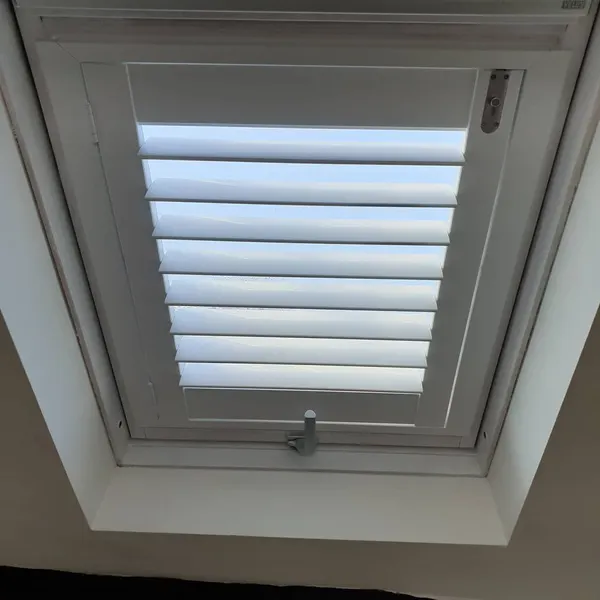 Grey skylight shutter, louvres opened to the sky
