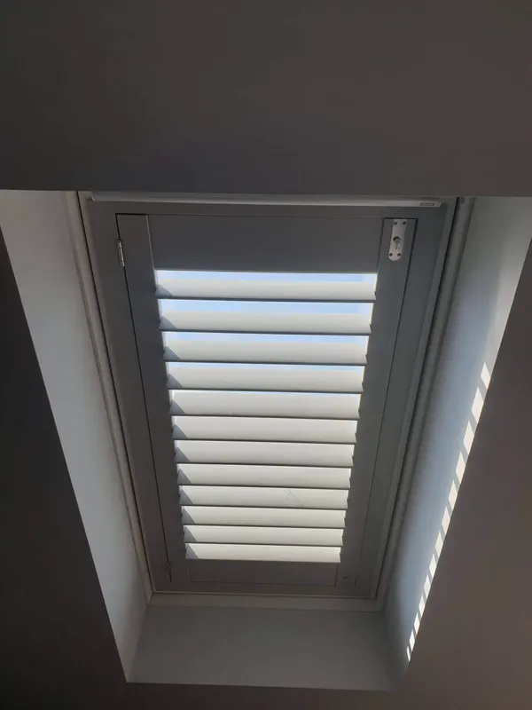 Steep sloped ceiling with a long skylight shutter