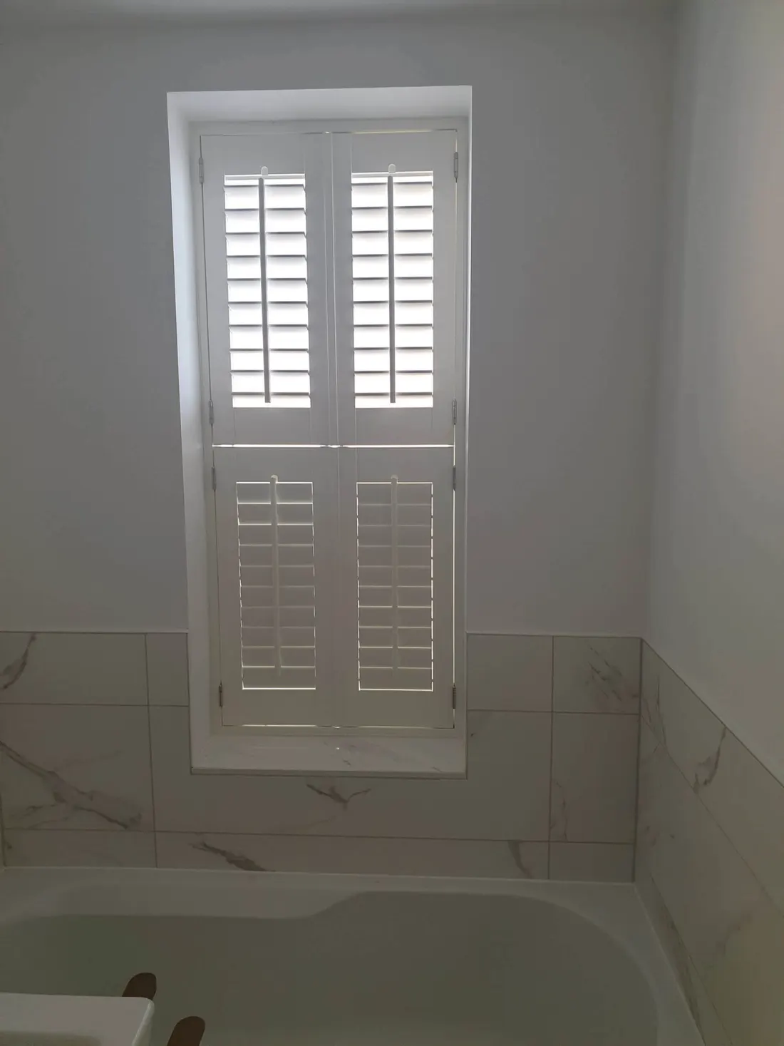 Bathroom window with tier-on-tier shutters
