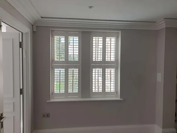 Two tier-on-tier shutters fitted to a landing window