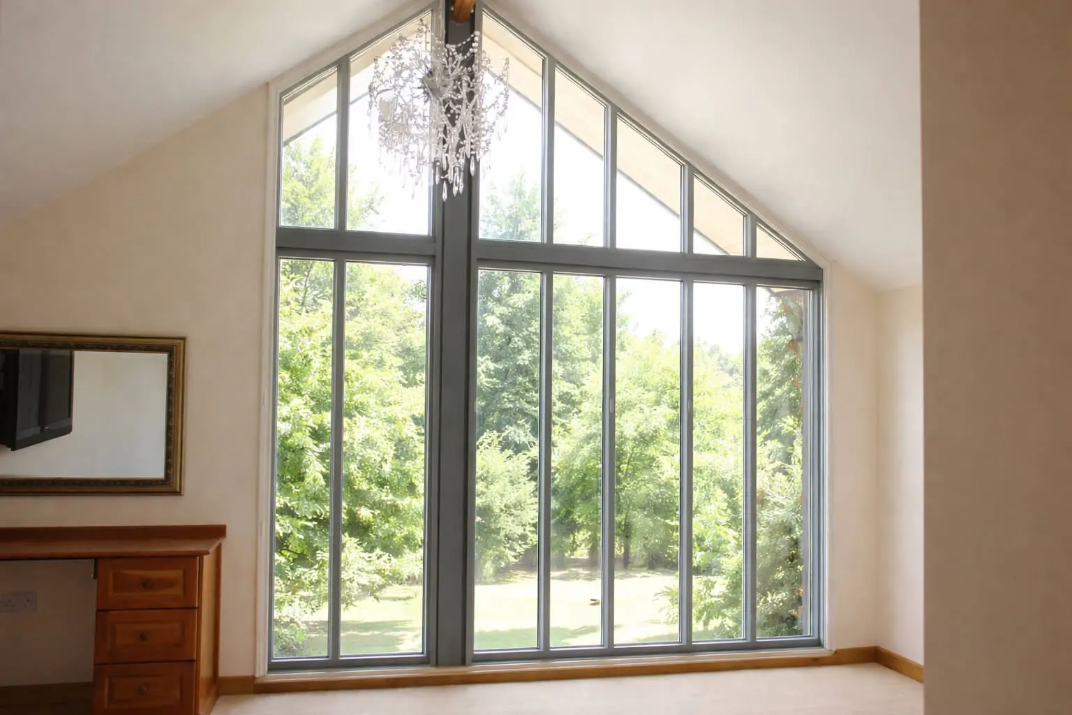 A customer's bedroom gable window with bare glass, before any shutters